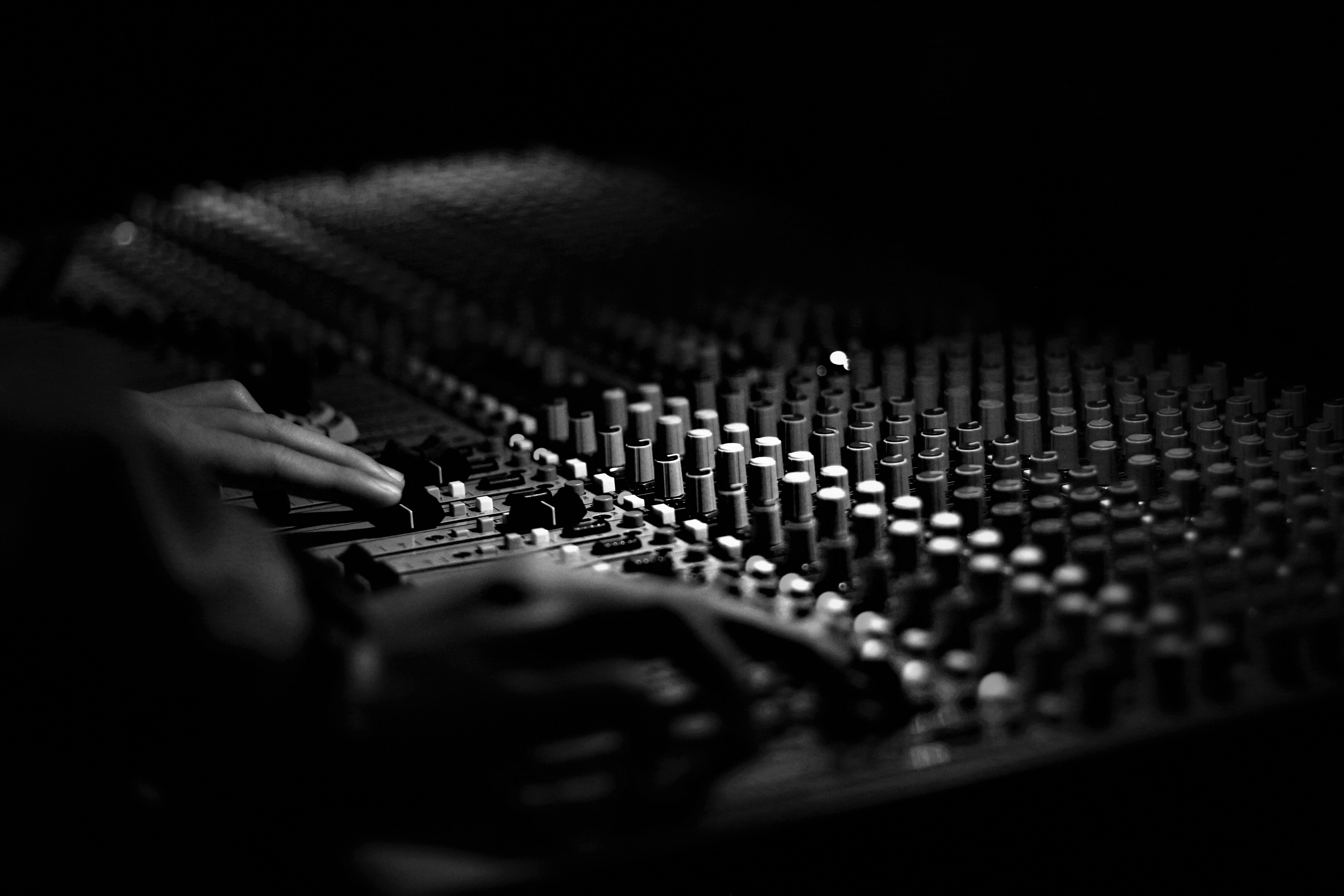 black and white photography of a mixing studio console in a studio
